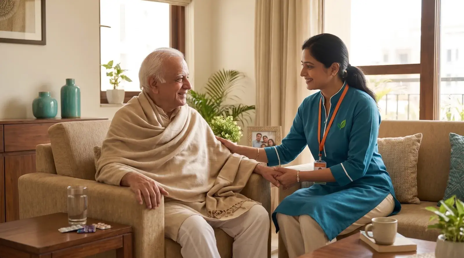 Verified Karuna caregiver holding the hand of a recovering patient resting at home